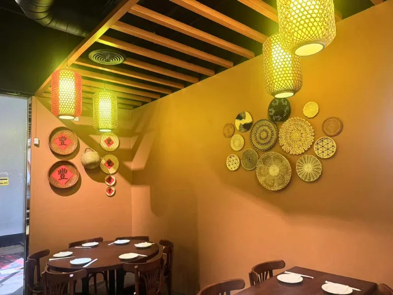 Wall with woven bamboo decor and warm lantern lighting at Picky Hunan, a Hunan Restaurant in Alhambra